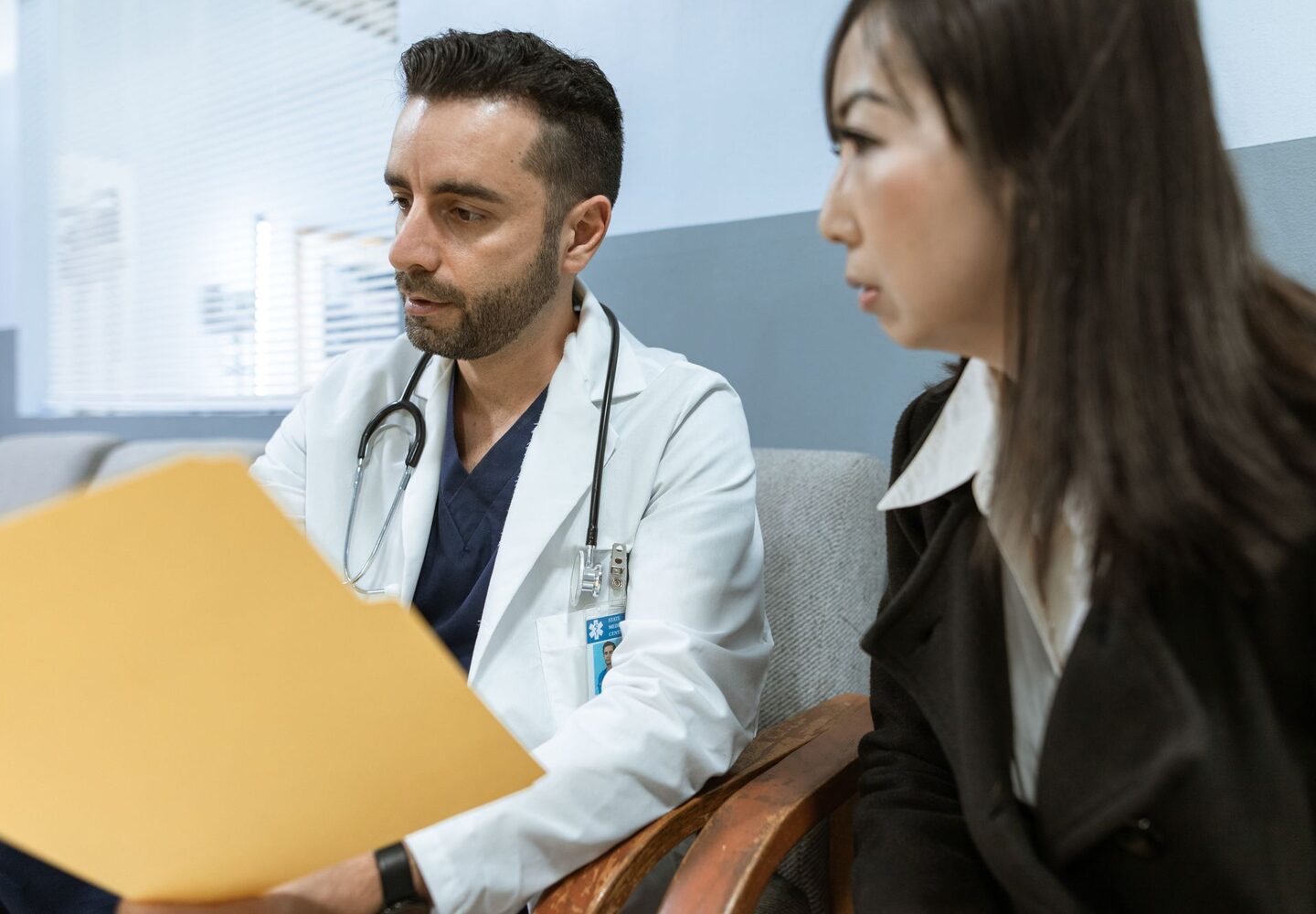 A doctor discussing medical records with a patient in a clinic
